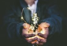 Upgrade Your Business Strategies With These Useful Tips And Tricks Man holding incandescent bulb