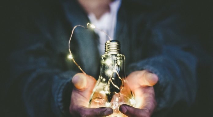 Upgrade Your Business Strategies With These Useful Tips And Tricks Man holding incandescent bulb