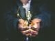 Upgrade Your Business Strategies With These Useful Tips And Tricks Man holding incandescent bulb