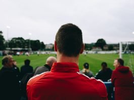 What A Good Betting Company Offers? Man standing while watching soccer during daytime
